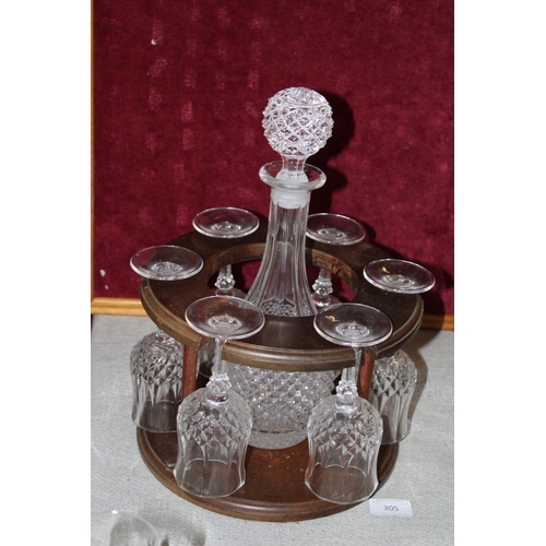 305 - A cut glass and set of six glasses on wooden stand