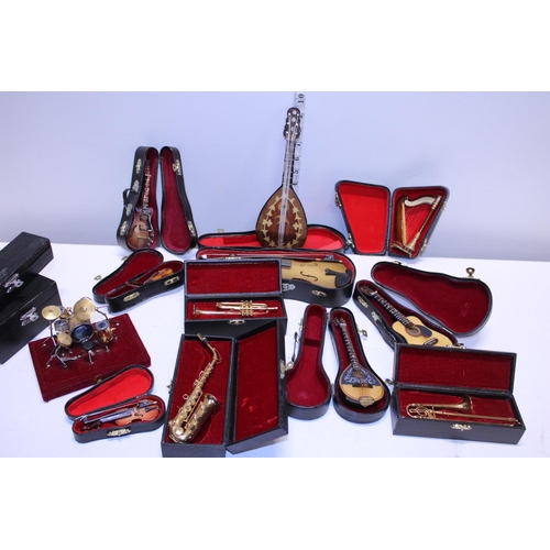 305 - A selection of miniature musical instruments & some empty cases