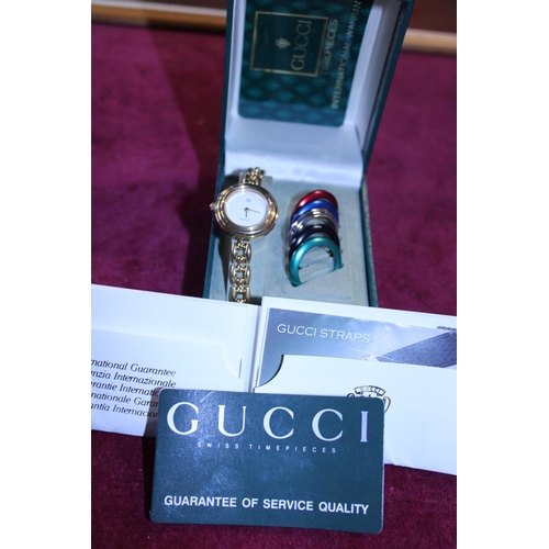 430 - A vintage Ladies Gucci watch with changeable bezels. With box and paperwork etc.