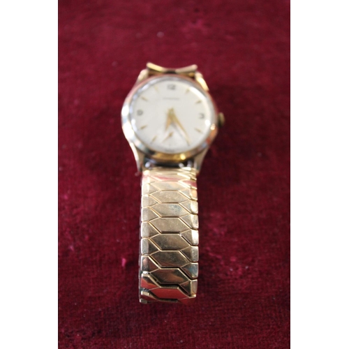 286 - A vintage 9ct gold bodied Garrard men's wrist watch in working order with dedication to reverse