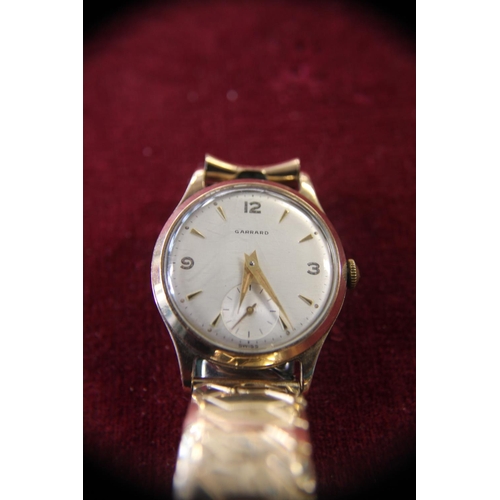 286 - A vintage 9ct gold bodied Garrard men's wrist watch in working order with dedication to reverse