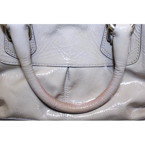 114 - A ladies Coach handbag, slight discolouration and mark on handle.