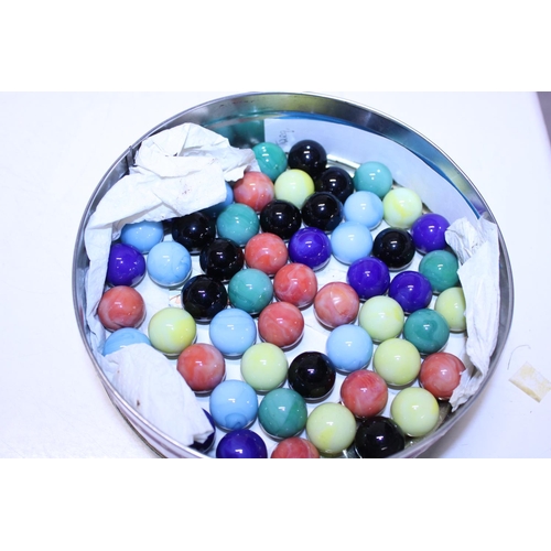 77 - A tin of vintage glass marbles