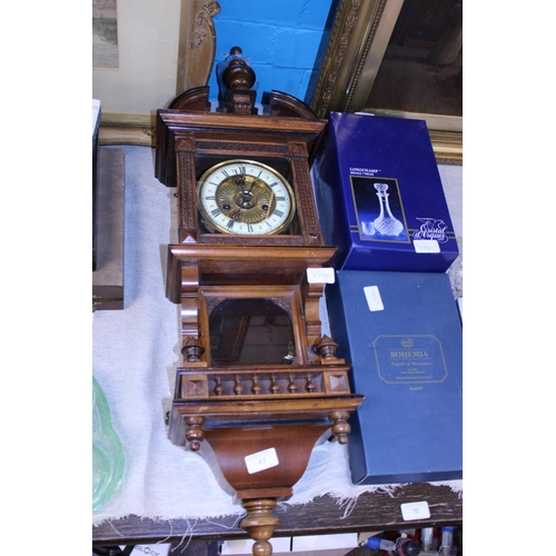 309 - An antique Vienna wall clock in working order with pendulum and key.  Postage unavailable