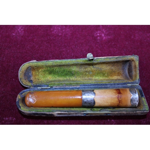 179 - An antique cased amber and silver mount cheroot holder