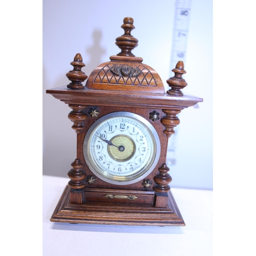 365 - A vintage small wooden mantle clock with wind up movement (has been overwound)