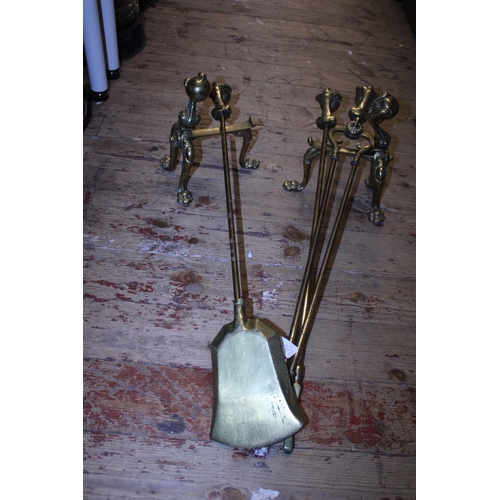 384 - A set of vintage brass firedogs and a set of fireside implements,  shipping unavailable