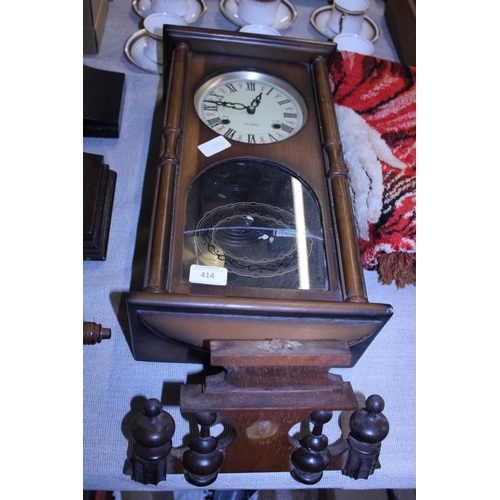 414 - A vintage 31 day wall clock with key and pendulum.  shipping unavailable