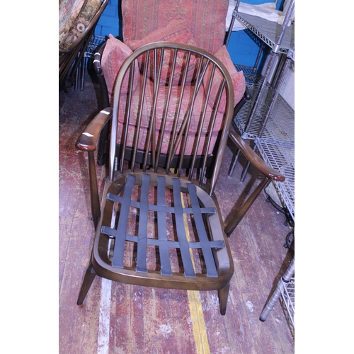 434 - A vintage Ercol armchair. With spindle back Postage unavailable