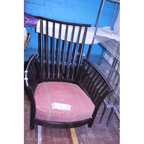 435 - A vintage Ercol armchair. With spindle back.  Postage unavailable