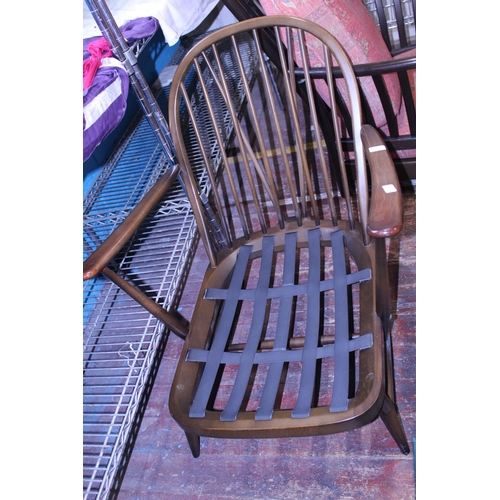 436 - A vintage Ercol armchair. With spindle back.  Postage unavailable