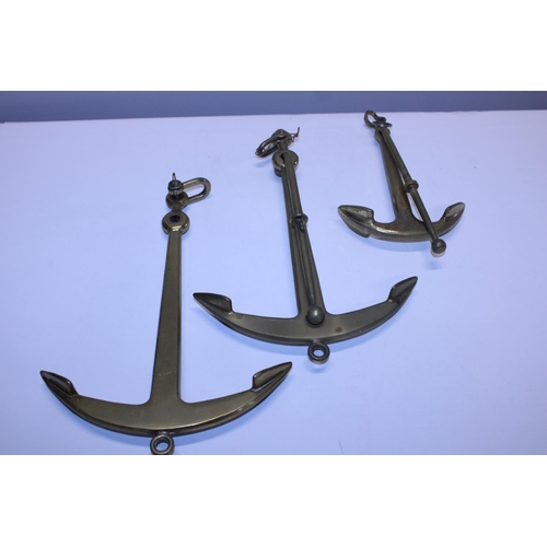 15 - Three brass graduated anchors