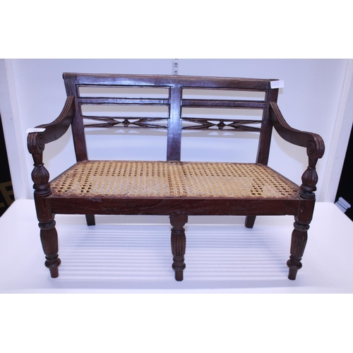 342 - A antique child's bench with cane work seat. Shipping unavailable