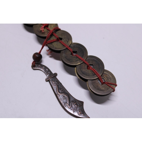 196 - A brass Chinese lucky money coin and a Chinese coin sword