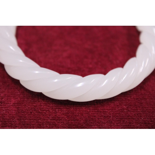 233 - A Chinese White Jade bracelet finely carved with twist design