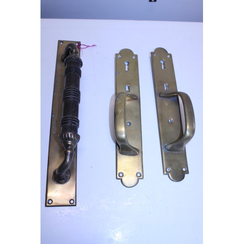 349 - A pair of Victorian brass door handles and one other