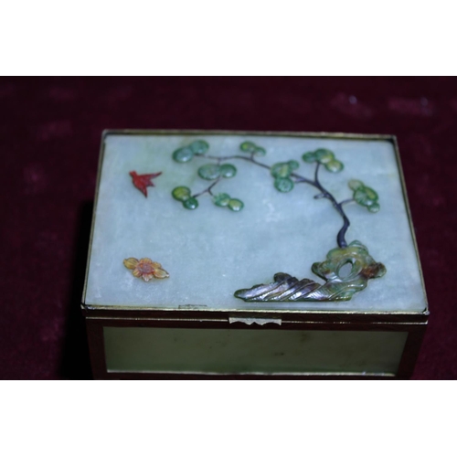 247A - An unusual green jade box with brass mounts, decorated with trees & birds