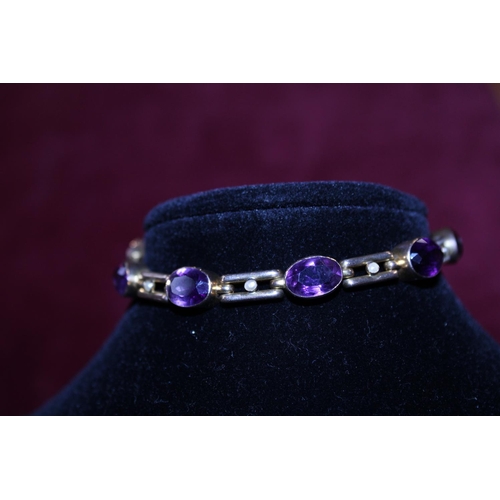 240 - A hallmarked 9ct gold bracelet with Amethyst and Seed pearl decoration and safety chain gross weight... 