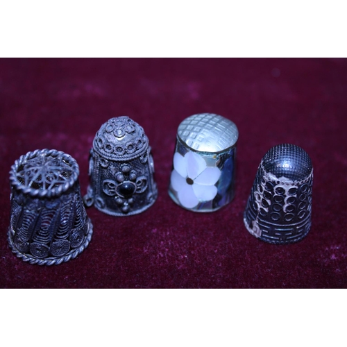 257 - Four assorted silver thimbles