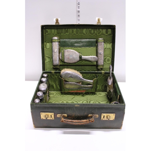 135 - A hallmarked silver mounted Gentlemen's vanity case retailed by Harrods. (some dents to silver lids ... 