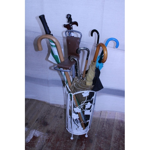 280 - A vintage metal umbrella/stick stand and contents, shipping unavailable