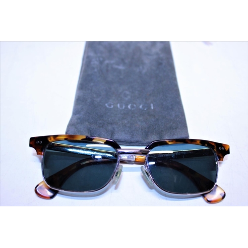 108 - A pair of Gucci tortoise shell form sunglasses