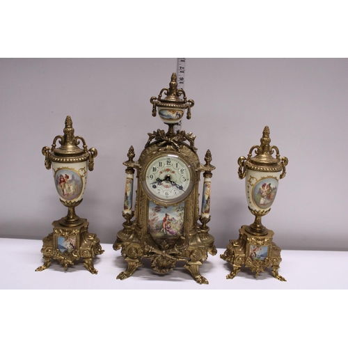 210 - A gilt brass mantle clock with two garnitures, movement by Franz Hermle. Shipping unavailable