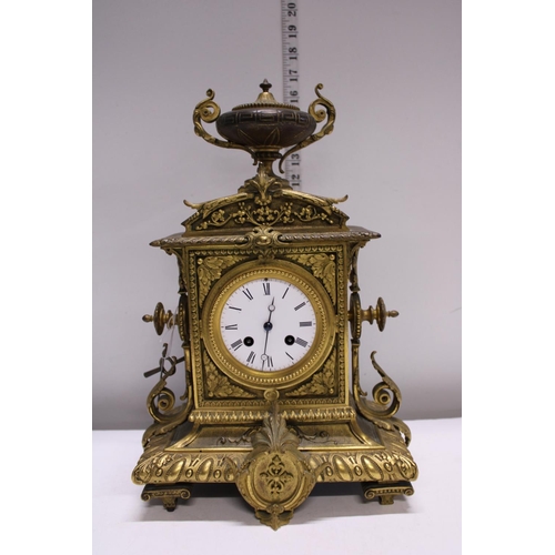 211 - A heavy gilt brass mantle clock with enamel face, with key and pendulum. Shipping unavailable