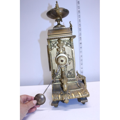 211 - A heavy gilt brass mantle clock with enamel face, with key and pendulum. Shipping unavailable