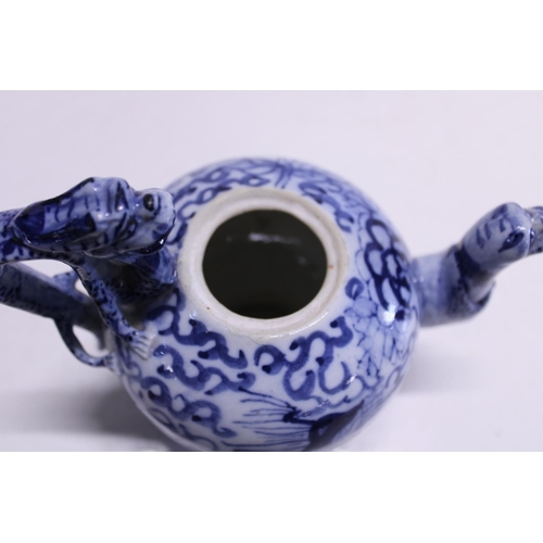 83 - A Chinese porcelain dragon form blue and white teapot with character marks to the base