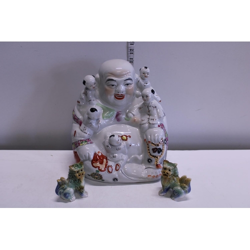 19 - A ceramic porcelain Budda and two small Fou Dogs