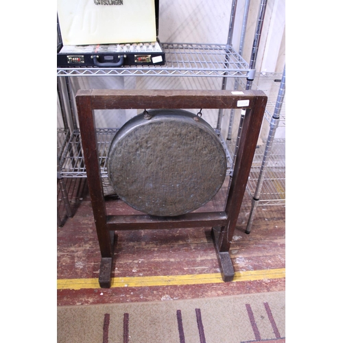 81 - A vintage large brass dinner gong on wooden frame, shipping unavailable