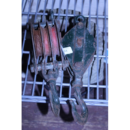 91 - Two vintage metal pulley's.  No postage