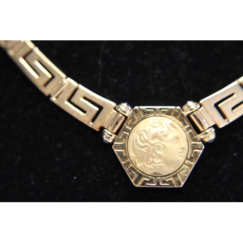 115 - A quality 18ct gold necklace in greek key design. With a 18ct gold coin pendant set with four small ... 