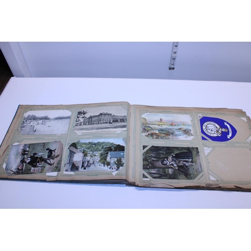 129 - A antique album of real photographs and printed postcards etc