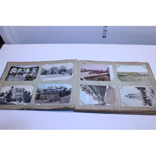 129 - A antique album of real photographs and printed postcards etc