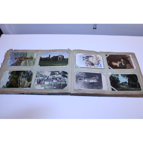 129 - A antique album of real photographs and printed postcards etc