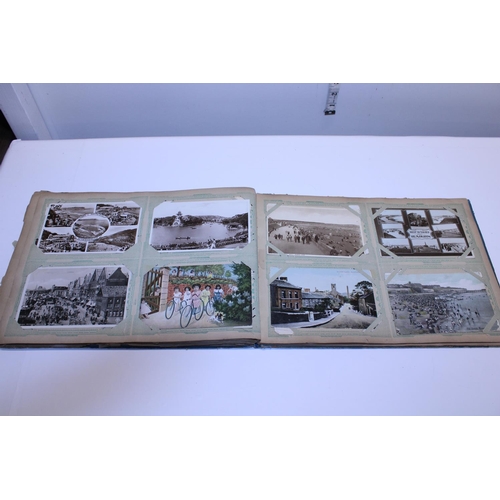 129 - A antique album of real photographs and printed postcards etc