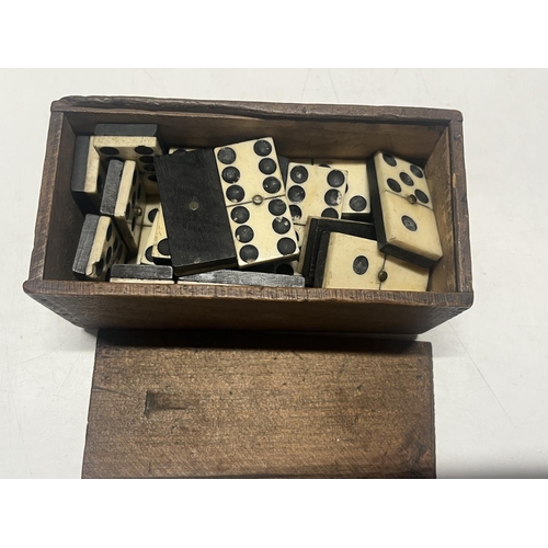 124 - A box of antique bone dominoes