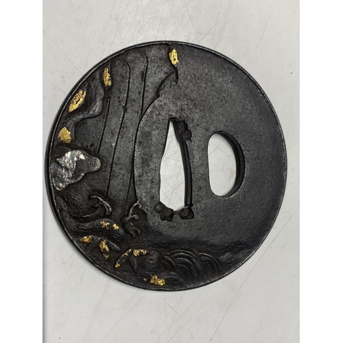 219 - A 18th century Japanese iron Tsuba sword guard with gilt decoration