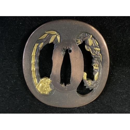 220 - A 18th century Japanese Tsuba sword guard with gilt decoration