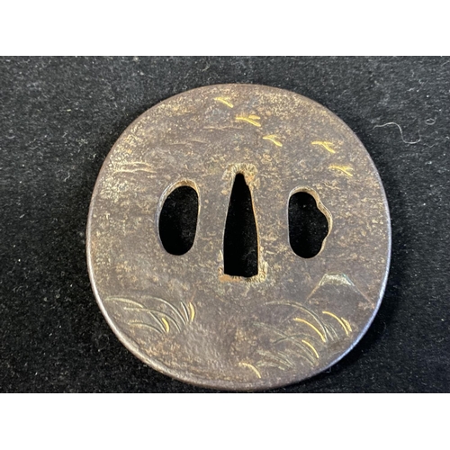 223 - A 18th century Japanese iron Tsuba sword guard with gilt decoration