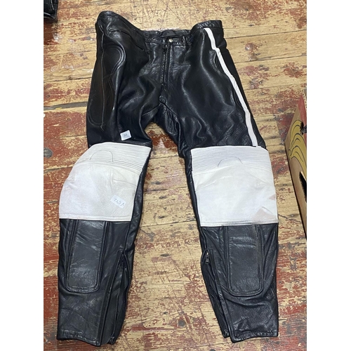 324 - A pair of unbranded leather motorcycle trousers worn