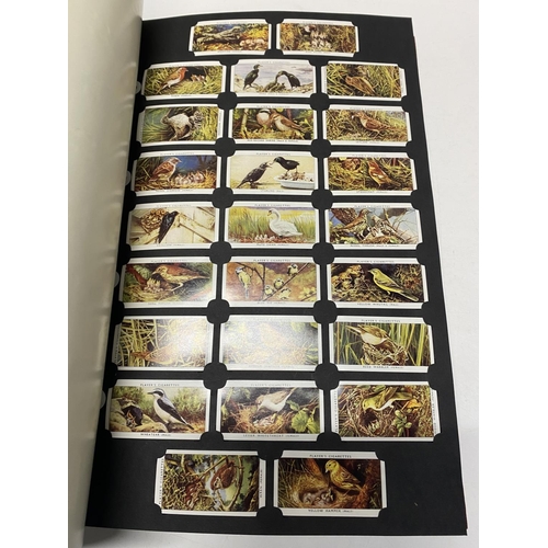 348 - A card collectors society folder full of reprint cigarette cards