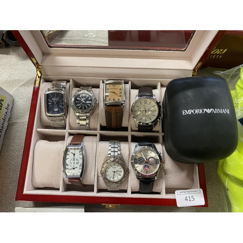 415 - A selection of assorted watches in display case and one boxed Emporio Armani ladies watch