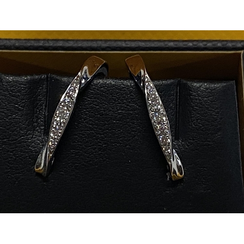 115 - A pair of 9ct gold and diamond earrings. 2.10 grams