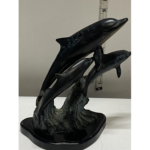 154 - A bronzed metal sculpture of three dolphins