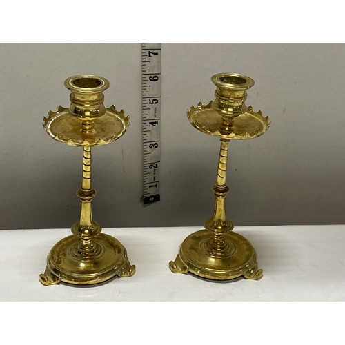 171 - A pair of antique brass candlesticks