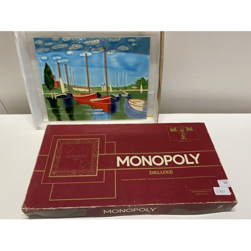 39 - A boxed Monopoly deluxe board game (unchecked) and a ceramic plaque