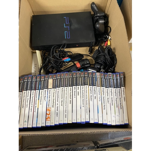 28 - A PS2 console with controllers and a good selection of games (working)